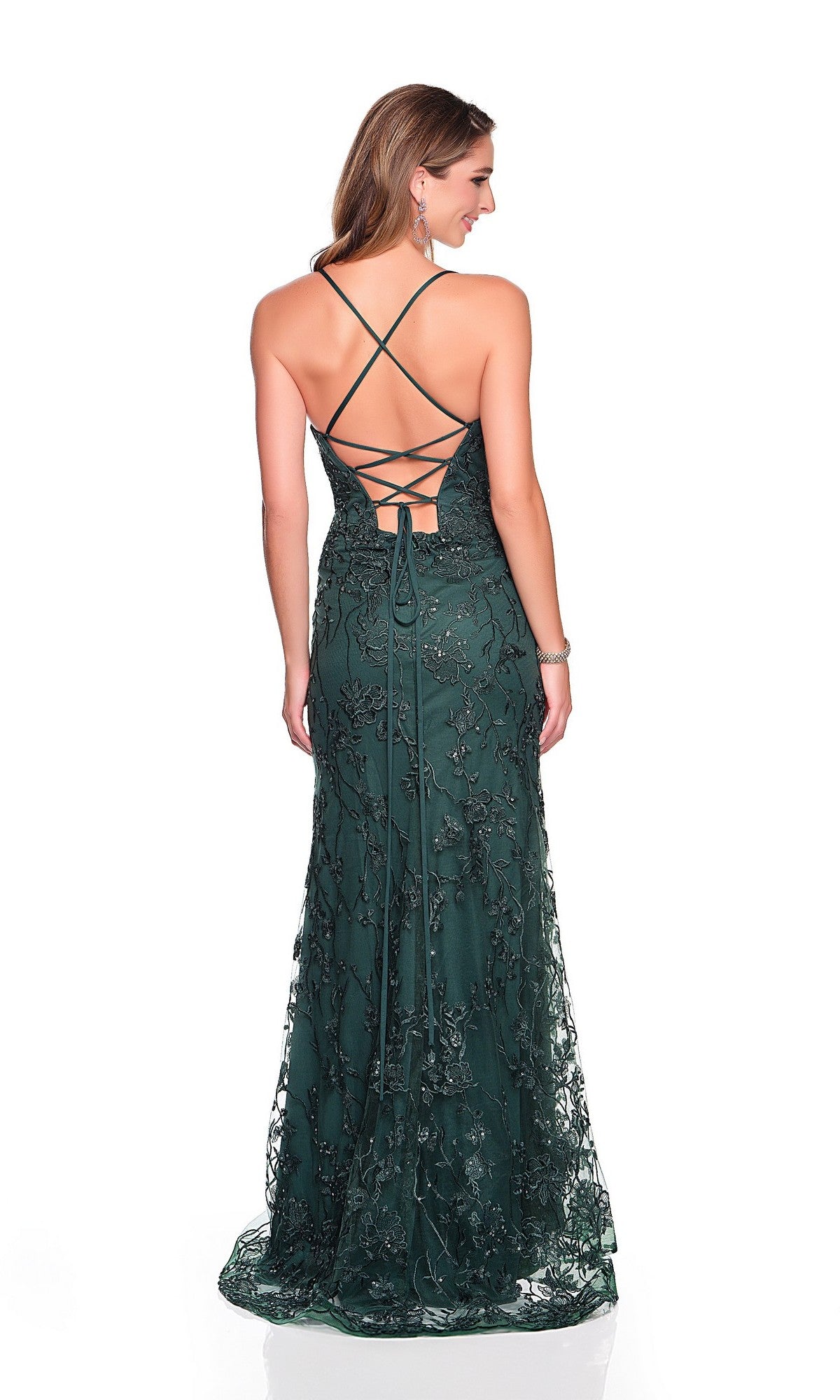 A woman stands with her back to the camera, wearing the Dave and Johnny 12409 long prom dress in emerald green, featuring sequin detailing and a lace-up back, against a white background.